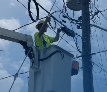 Man in truck working on cables